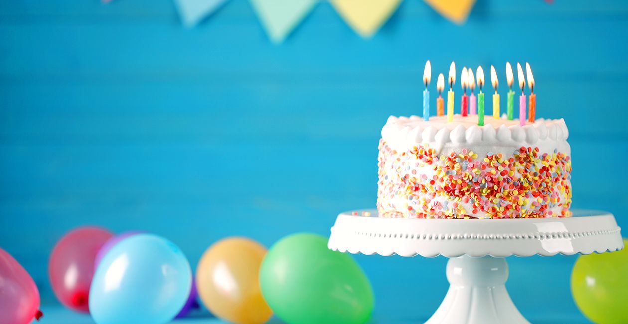 Photograph showing birthday cake and baloons